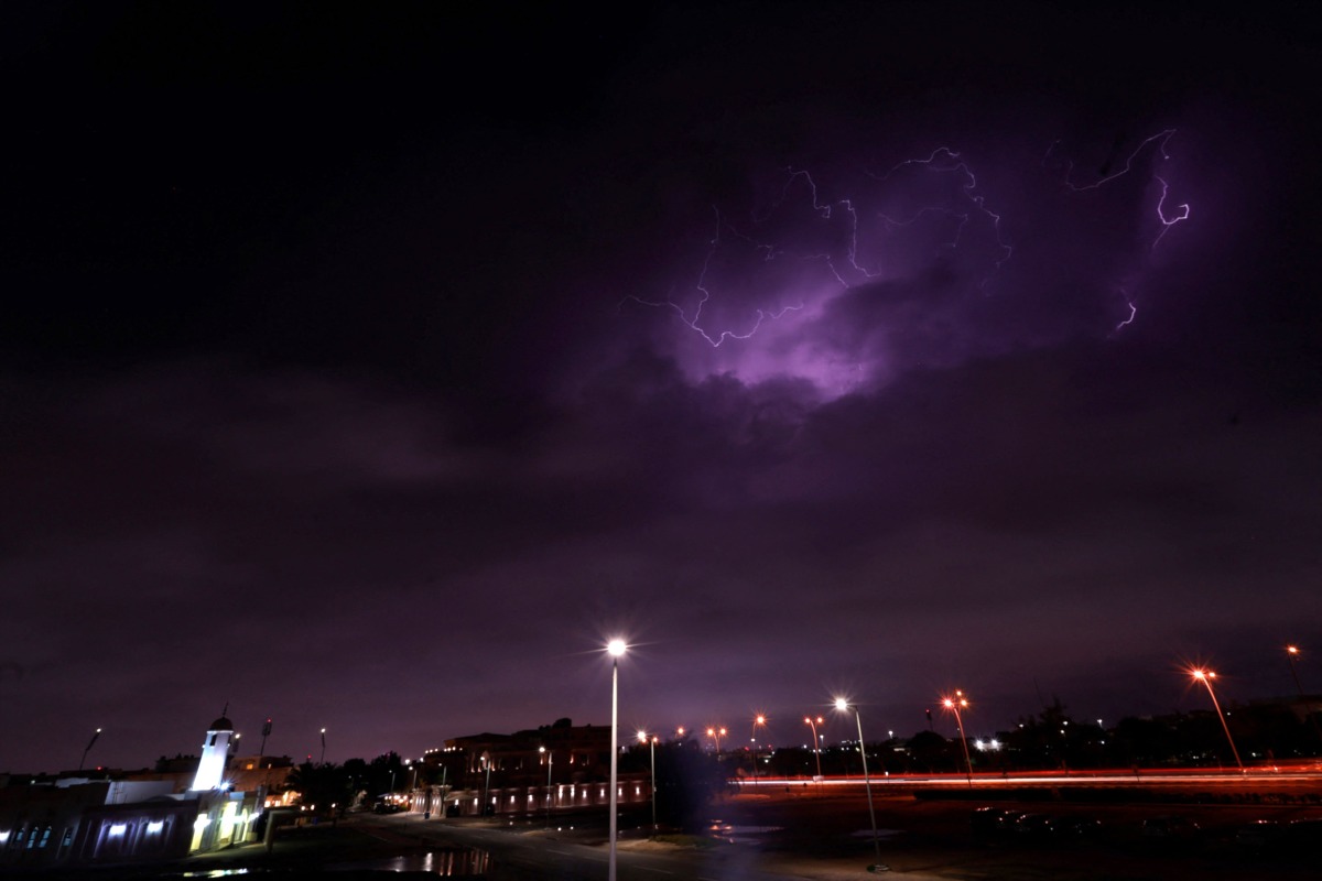 Lightning streaks across the sky during a thunderstorm over Doha on March 25, 2026. Photo by Karim JAAFAR / AFP