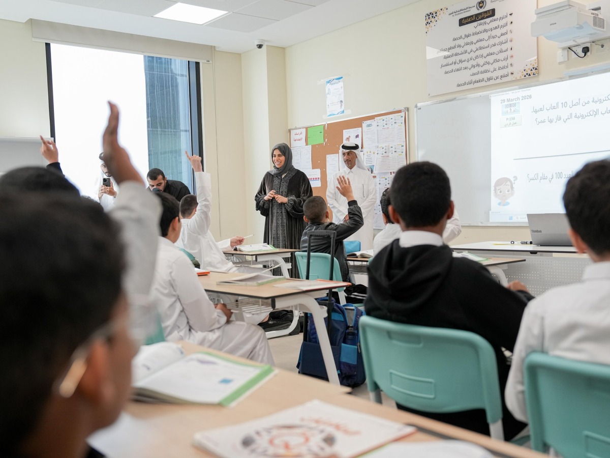 Minister of Education and Higher Education H E Lolwah bint Rashid Al Khater interacts with students in a classroom during her visit to a school yesterday.