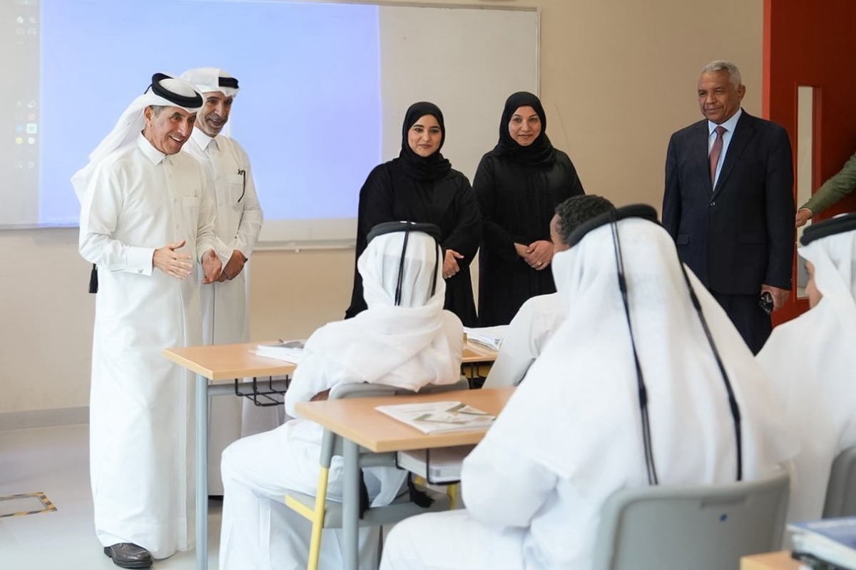 Undersecretary of the Ministry of Education and Higher Education H E Dr. Ibrahim bin Saleh Al-Nuaimi interacts with students in a classroom during his visit to a school.