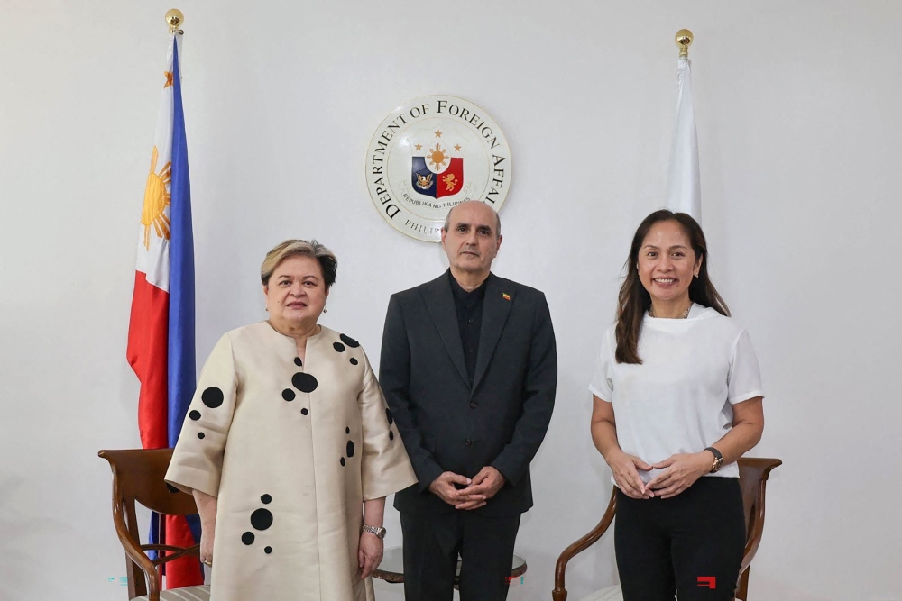 In this handout photo taken April 1, 2026 and released by the Philippine Department of Foreign Affairs shows Philippine Secretary of Foreign Affairs Thereza Lazaro (L), Iranian Ambassador to the Philippines Yousef Esmaeilzadeh (C) and Philippine Secretary of Energy Sharon Garin posing for a photo during a bilateral meeting in Manila. (Photo by Handout / Philippine Department of Foreign Affairs / AFP) 
