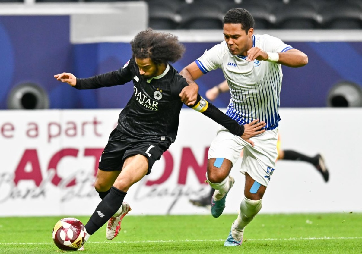 Al Sadd's Akram Afif (left) controls the ball
