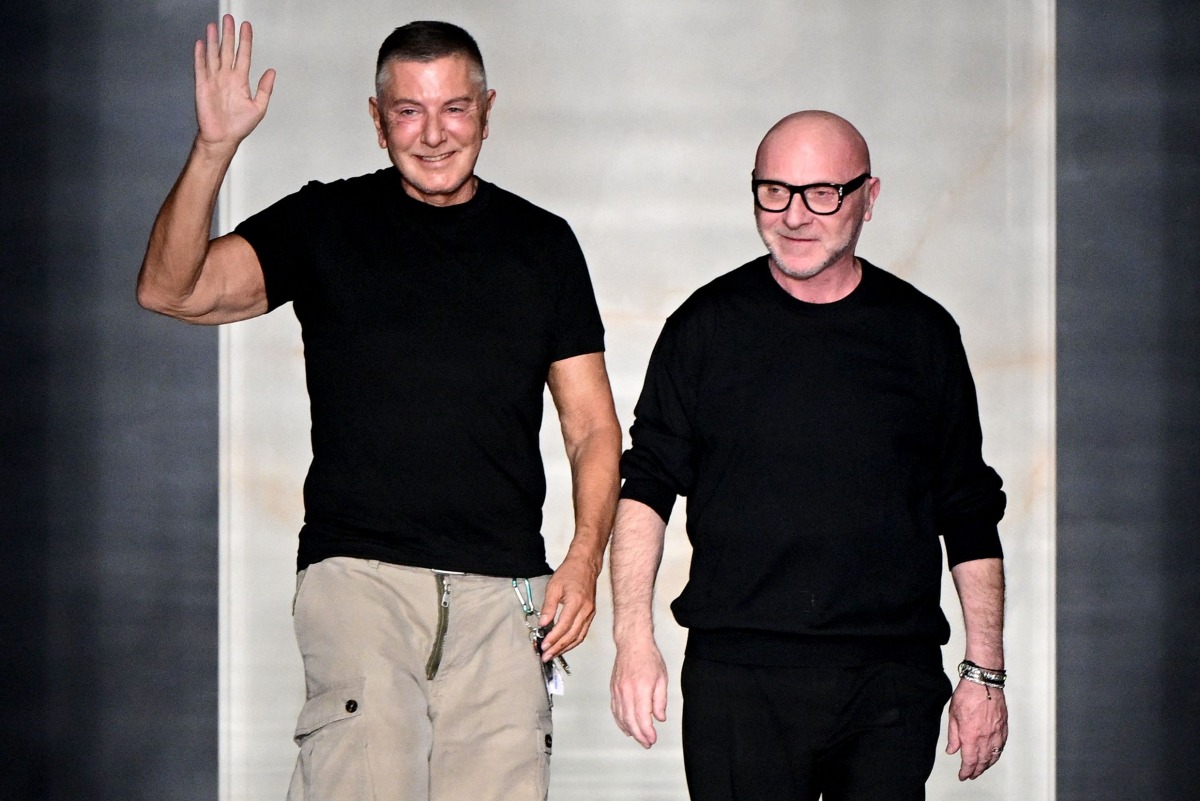 Italian stylists Domenico Dolce (R) and Stefano Gabbana (L) salute the audience at the end of the Dolce & Gabbana women's ready-to-wear Fall/Winter 2026 collection show as part of the Milan Fashion Week, in Milan on February 28, 2026. Photo by Miguel MEDINA / AFP
