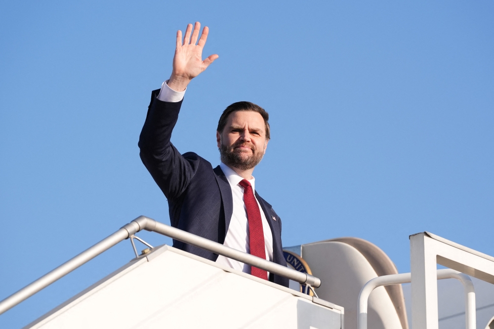 US Vice President JD Vance waves as he boards Air Force Two after attending talks on Iran in Islamabad on April 12, 2026. (Photo by Jacquelyn Martin / POOL / AFP)