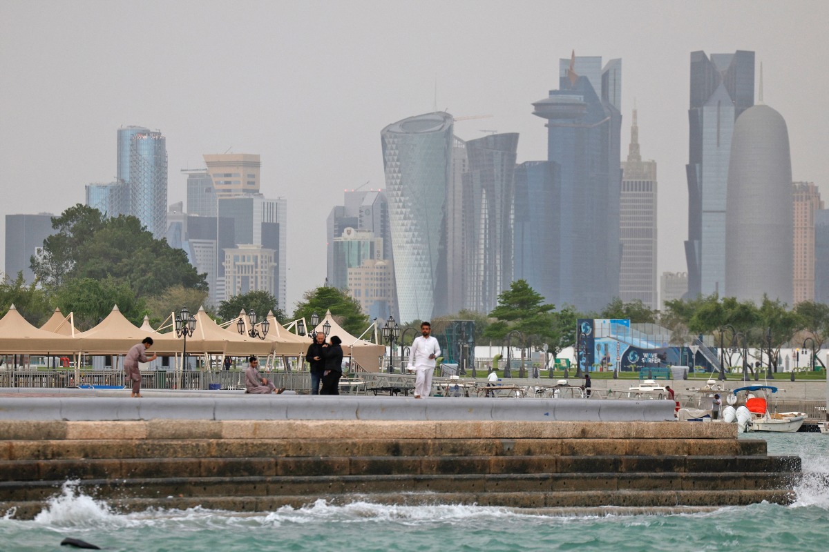 People visit the Corniche area of Doha on a cloudy day on April 9, 2026. (Photo by AFP)
