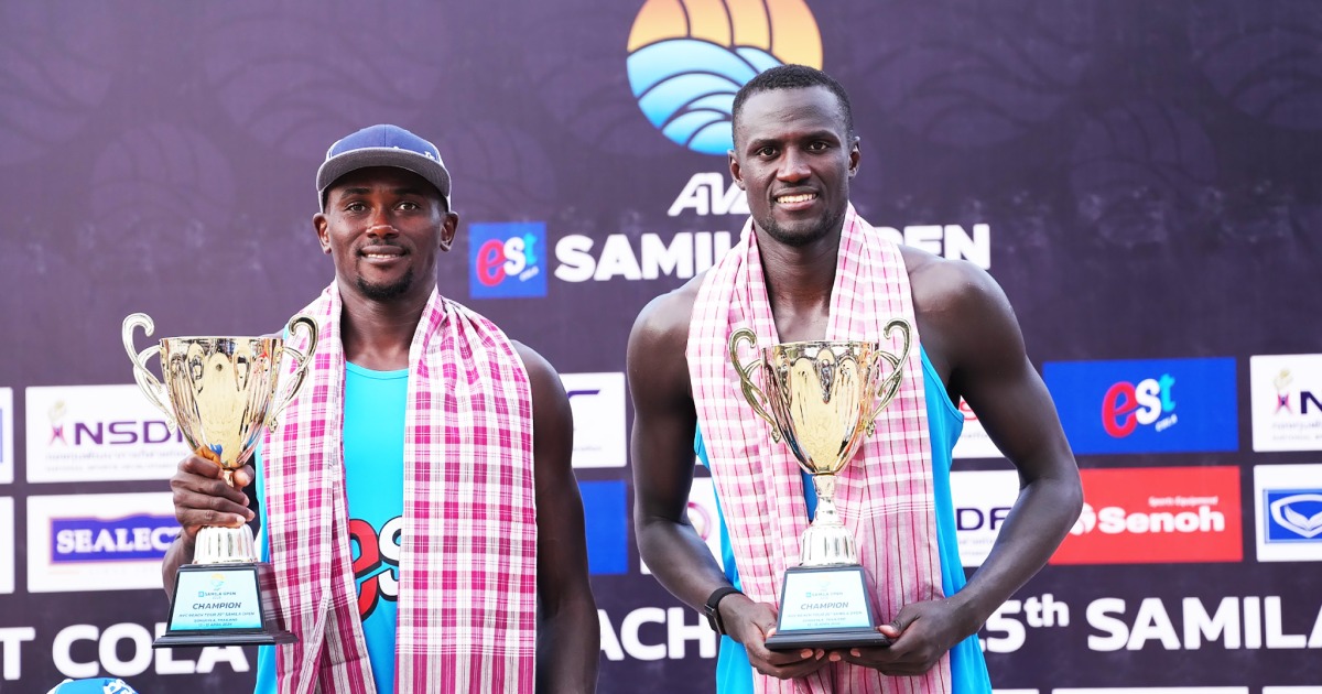 Qatar's Cherif Younousse (right) and Ahmed Tijan pose with their trophies.