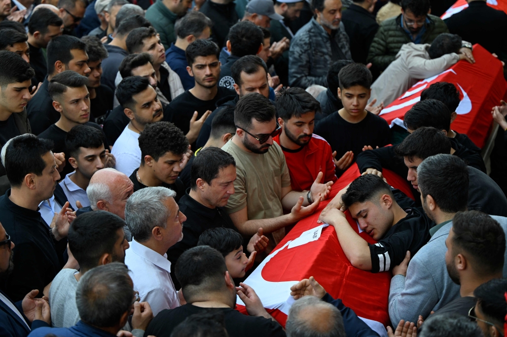 Family members and mourners attend the funerals for nine victims killed in a school shooting at the Abdulhamid Han Mosque in the southern province of Kahramanmaras on April 16, 2026. (Photo by Yasin Akgul / AFP)