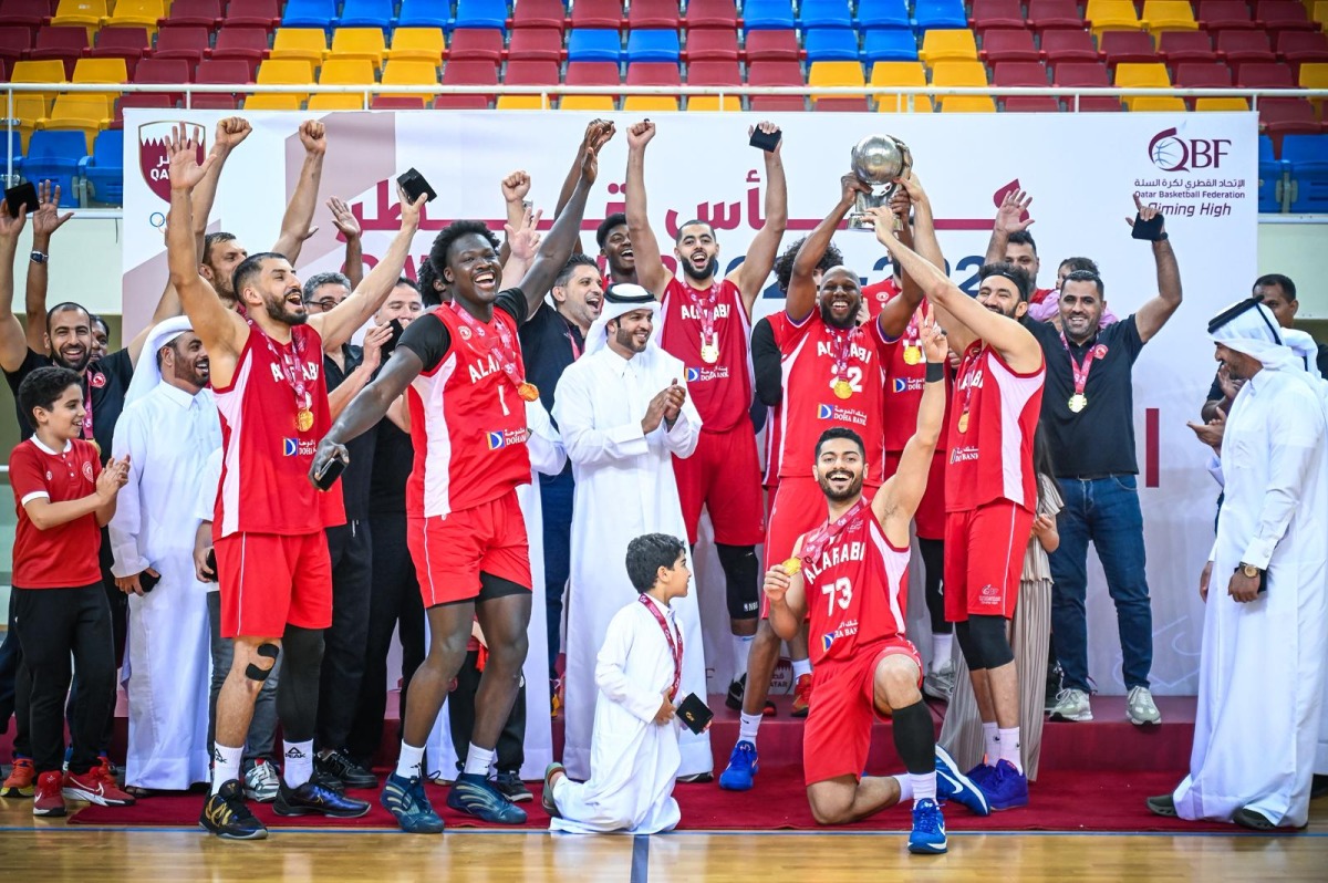 QBF President Mohammed bin Saad Al Mughaseeb applauds as Al Arabi players celebrate with the trophy. 