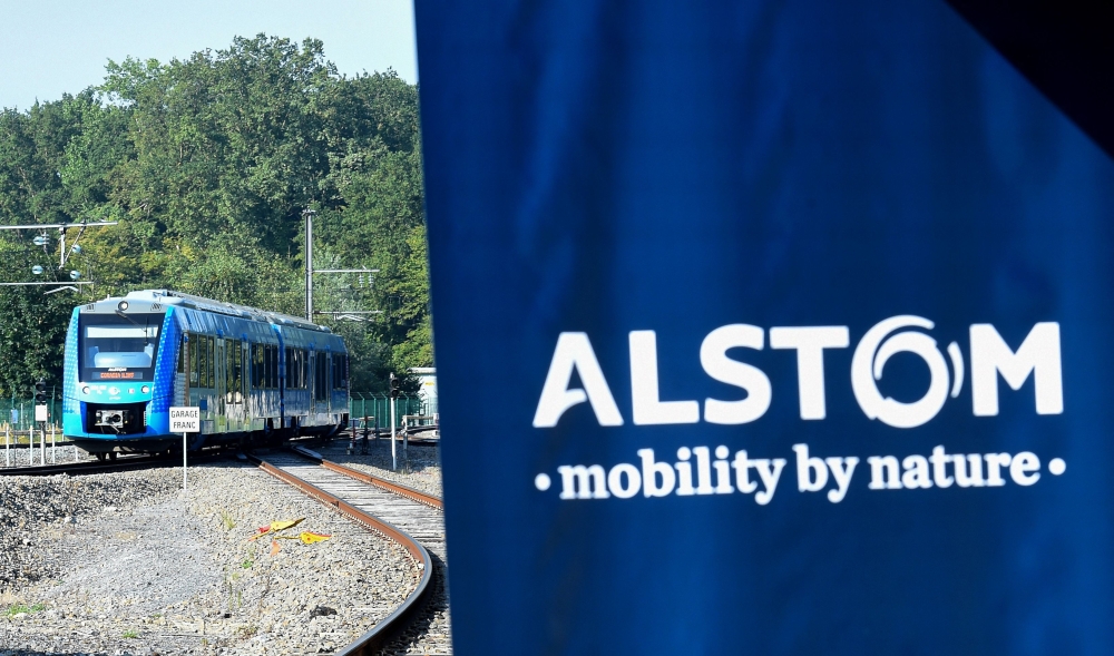 FILE PHOTO: This photograph taken on September 6, 2021 shows Alstom's logo and Alstom's Coradia iLint train, the first in the world to be powered by hydrogen, during its inauguration on the tracks of the Railway Test Center in Petite-Foret, northern France taken on September 6, 2021 . (Photo by Francois Lo Presti/ AFP)