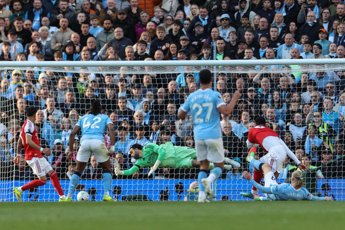 Manchester City's Norwegian striker #09 Erling Haaland (front R) shoots to score his team's second goal during the English Premier League football match between Manchester City and Arsenal at the Etihad Stadium in Manchester, north west England, on April 19, 2026. (Photo by Darren Staples / AFP)