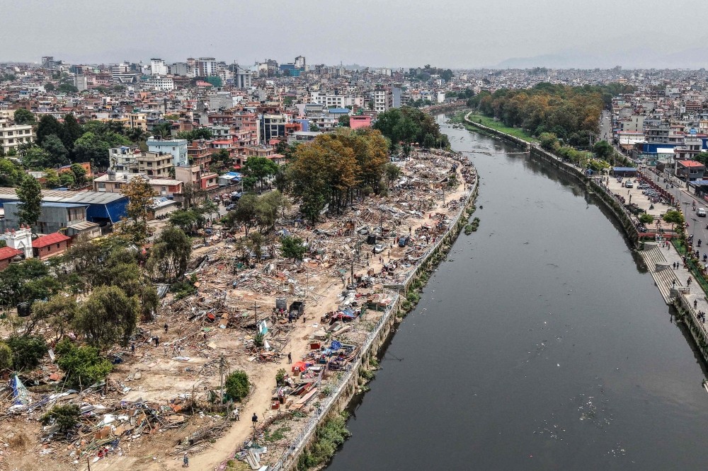 NEPAL-POLITICS-RIGHTS
An aerial view shows squatter settlements demolished by Nepali authorities along the banks of the river Bagmati in Kathmandu on April 25, 2026. (Photo by Prabin Ranabhat / AFP)