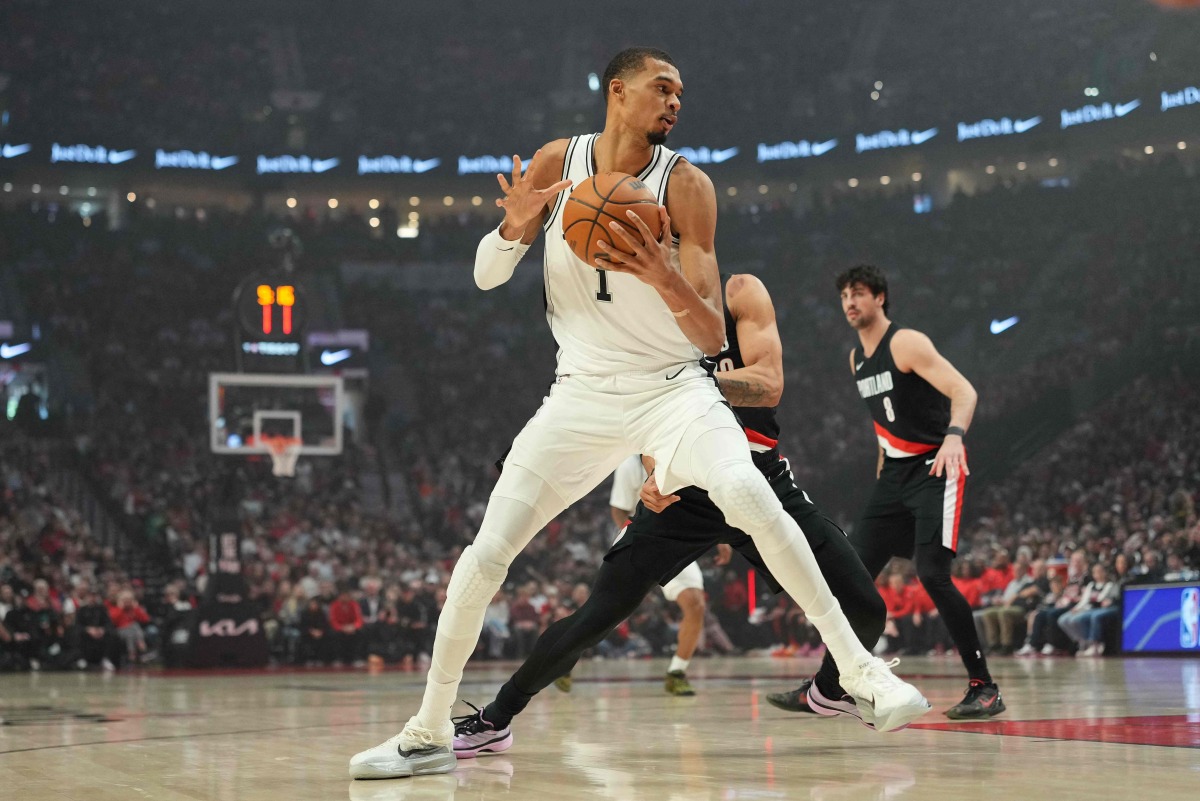 Victor Wembanyama #1 of the San Antonio Spurs posts up against Toumani Camara #33 of the Portland Trail Blazers during the first half of Game Four of the Western Conference First Round Playoffs at Moda Center on April 26, 2026 in Portland, Oregon. (Photo by Soobum Im / GETTY IMAGES NORTH AMERICA / Getty Images via AFP)