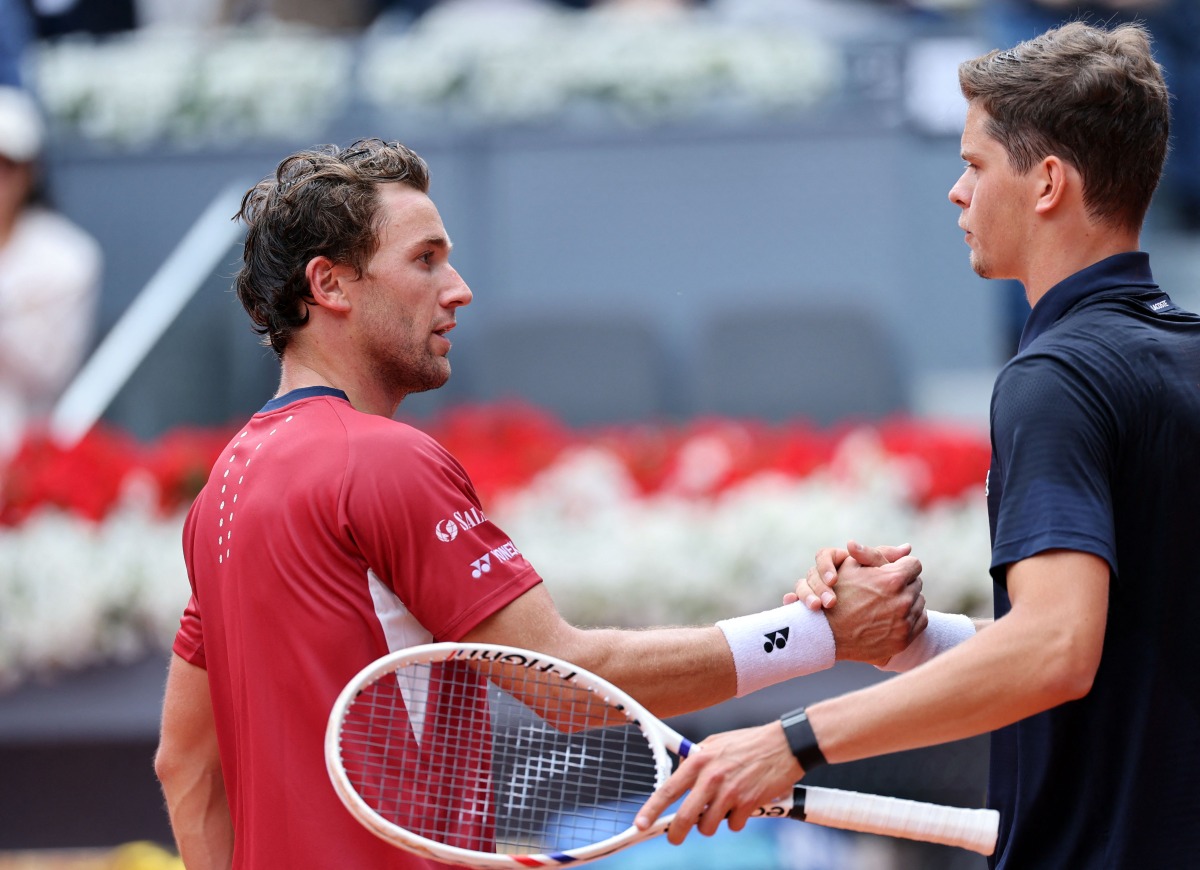 Belgium's Alexander Blockx shakes hands with Norway's Casper Ruud after beating him during their 2026 ATP Tour Madrid Open tennis tournament quarter-final singles match at the Caja Magica in Madrid, on April 30, 2026. (Photo by Thomas COEX / AFP)
