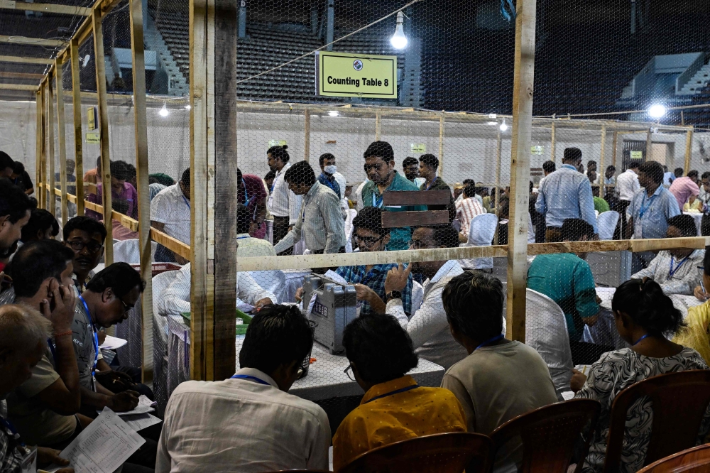Election officials count votes after the West Bengal Legislative Assembly elections at the Netaji Indoor Stadium in Kolkata on May 4, 2026. 
 (Photo by Dibyangshu SARKAR / AFP)