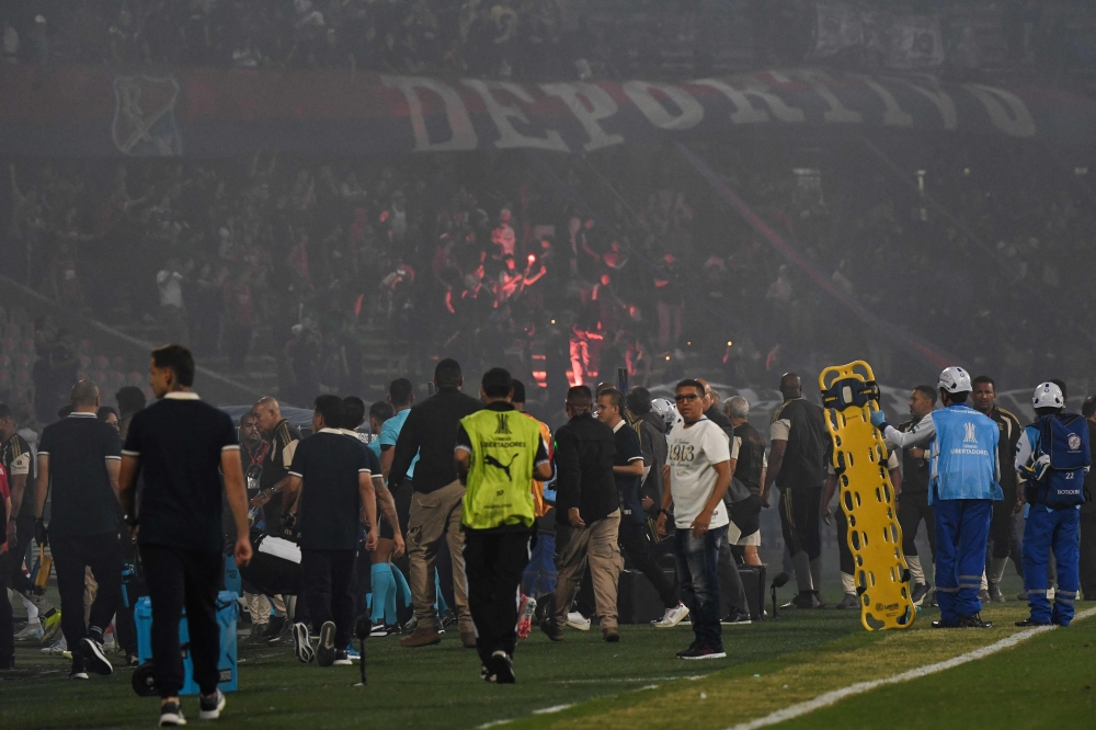 Medellin fans protest during the Copa Libertadores group stage football match between Colombia's Independiente Medellin and Brazil's Flamengo at the Atanasio Girardot stadium in Medellin, Antioquia department, Colombia on May 7, 2026. (Photo by Jaime Saldarriaga / AFP)
