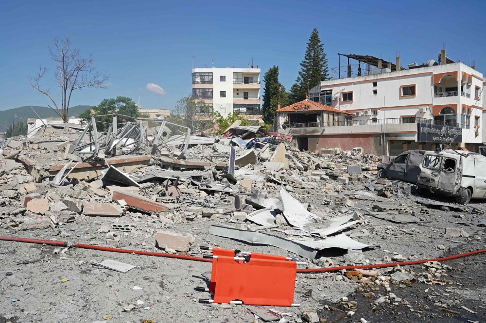A view of destroyed buildings is pictured at the site of an Israeli airstrike that targeted the southern Lebanese village of Habbouch on May 7, 2026. (Photo by Abbas Fakih / AFP)