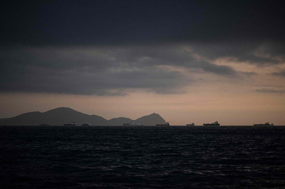 (Files) Image of merchant ships on the horizon in front of the port of El Callao in Lima on November 18, 2023. (Photo by Ernesto Benavides / AFP)