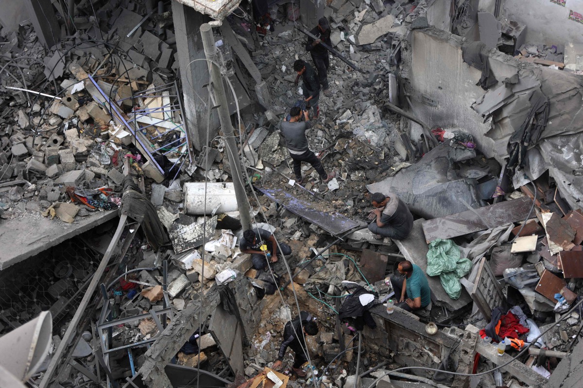 Palestinians inspect the site, a day after of an Israeli strike at the Shati refugee camp (Beach) in Gaza City, on May 9, 2026. Photo by Omar AL-QATTAA / AFP