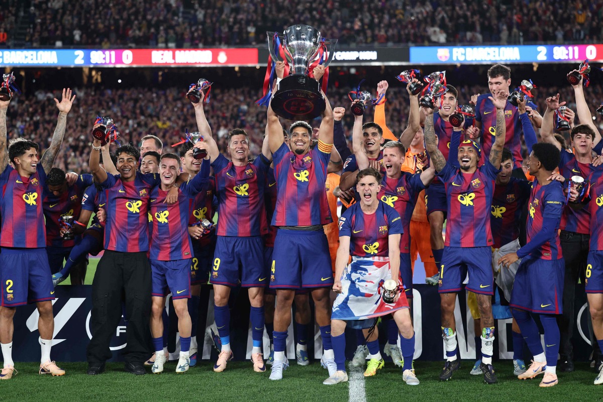 Barcelona's team celebrates winning the 2025-2026 Spanish League after the Spanish league football match between FC Barcelona and Real Madrid CF at Camp Nou Stadium in Barcelona on May 10, 2026. (Photo by Josep LAGO / AFP)