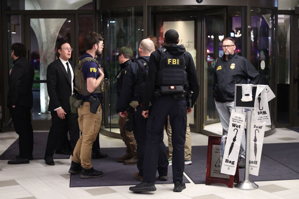 FBI agents are seen in the lobby of the Washington Hilton after shots were fired during the White House Correspondents' Dinner in Washington, DC, on April 25, 2026. (Photo by Alex Wroblewski / AFP)
