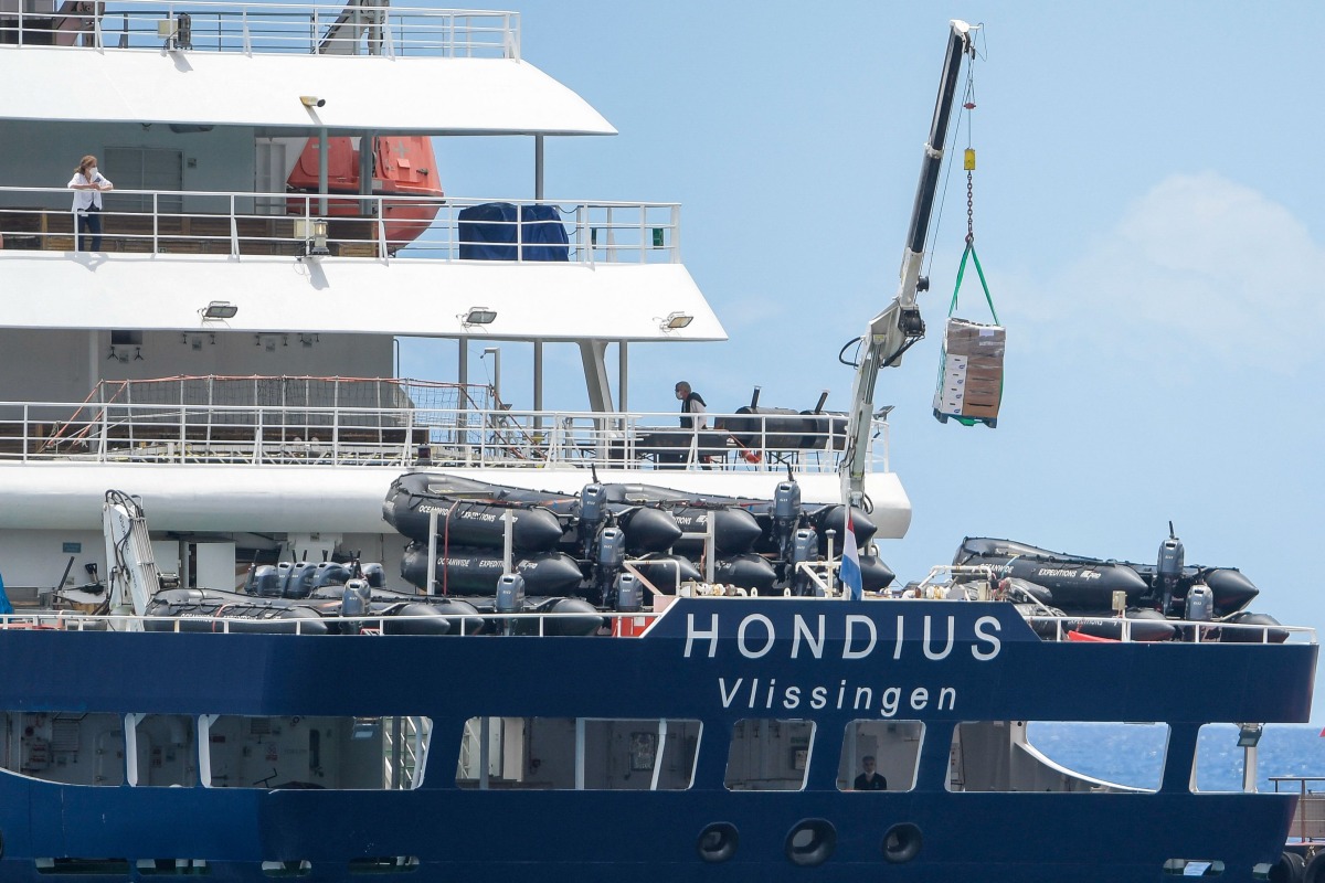 The Dutch flagged hantavirus-stricken cruise ship MV Hondius receives provisions from a boat in the port of Granadilla de Abona on the island of Tenerife in Spain's Canary Islands on May 11, 2026. Photo by JORGE GUERRERO / AFP