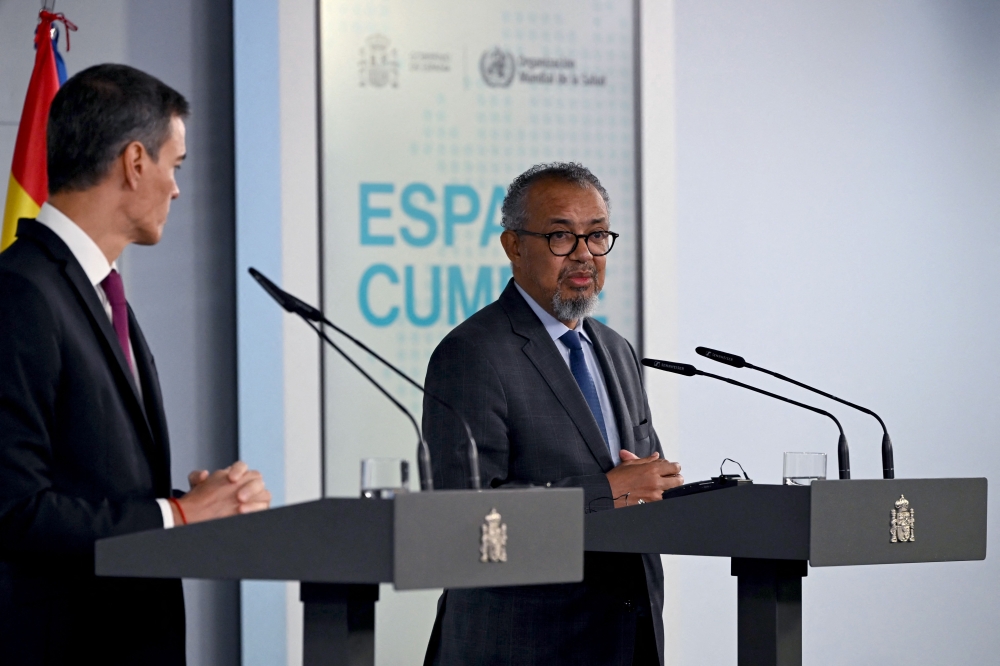 Spain's Prime Minister Pedro Sanchez (L) and World Health Organization (WHO) Director-General Tedros Adhanom Ghebreyesus give a joint press conference at the Moncloa Palace in Madrid on May 12, 2026. WHO chief said 'work not over' after hantavirus evacuation, AFP reports. (Photo by Javier Soriano/ AFP)