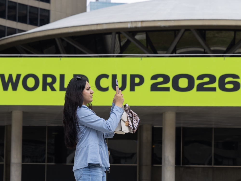 A visitor films the FIFA World Cup 2026-themed decorations at Nathan Phillips Square in Toronto, Canada, on May 11, 2026. (Photo by Zou Zheng/Xinhua)