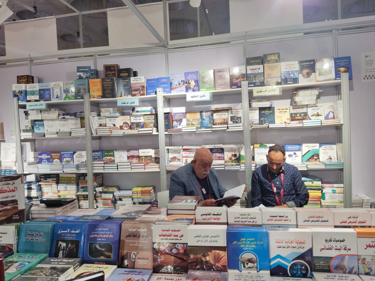 Abdulmonem Kamil (left) at his booth.