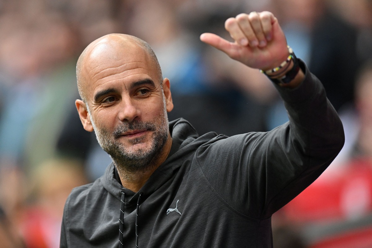 (FILES) Manchester City's Spanish manager Pep Guardiola waves to the fans ahead of the English FA Cup semi-final football match between Manchester City and Sheffield United at Wembley Stadium in north west London on April 22, 2023. (Photo by Glyn KIRK / AFP)