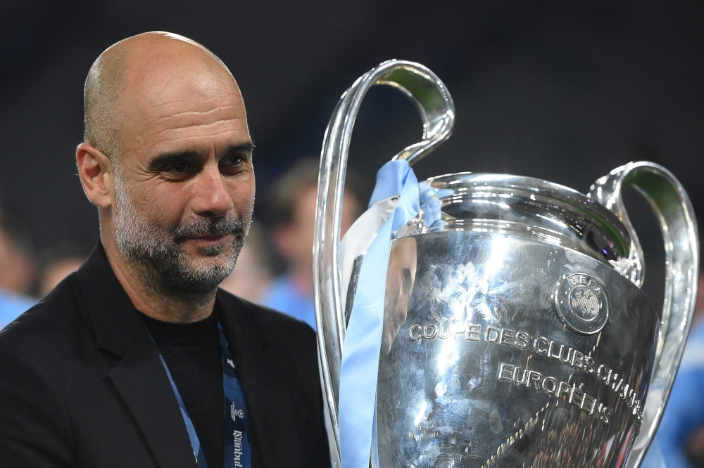 (Files) Manchester City's Spanish manager Pep Guardiola celebrates with the European Cup trophy on June 10, 2023. (Photo by Franck Fife / AFP)
 