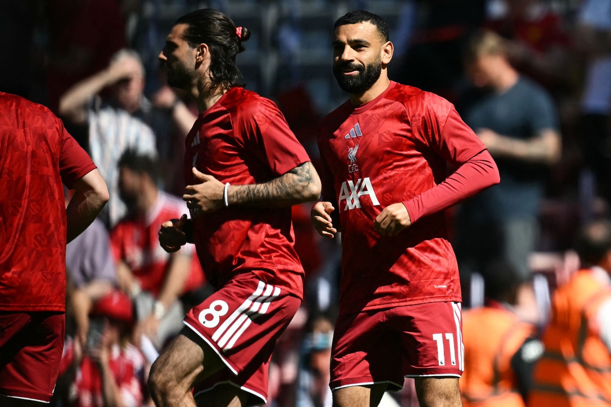 Liverpool's Hungarian midfielder #08 Dominik Szoboszlai (L) and Liverpool's Egyptian striker #11 Mohamed Salah (R) warm up ahead of the English Premier League football match between Liverpool and Brentford at Anfield in Liverpool, north west England on May 24, 2026. (Photo by Paul ELLIS / AFP)