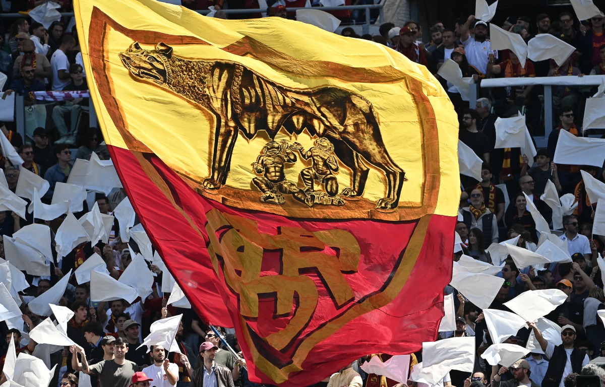 Roma's supporters wave a giant flag ahead of the Italian Serie A football match between Roma and Lazio at Olympic stadium in Rome on May 17, 2026. (Photo by Isabella BONOTTO / AFP)
