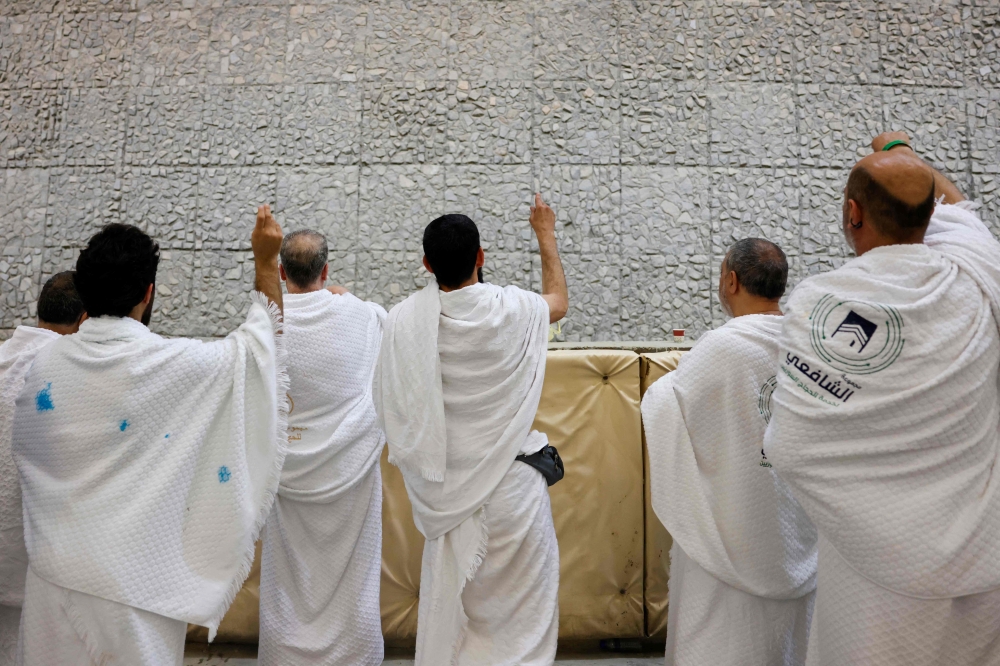 Muslim pilgrims perform the symbolic 'stoning of the devil' ritual as part of the Hajj pilgrimage in Mina on May 27, 2026. (Photo by Zain Jaafar / AFP)