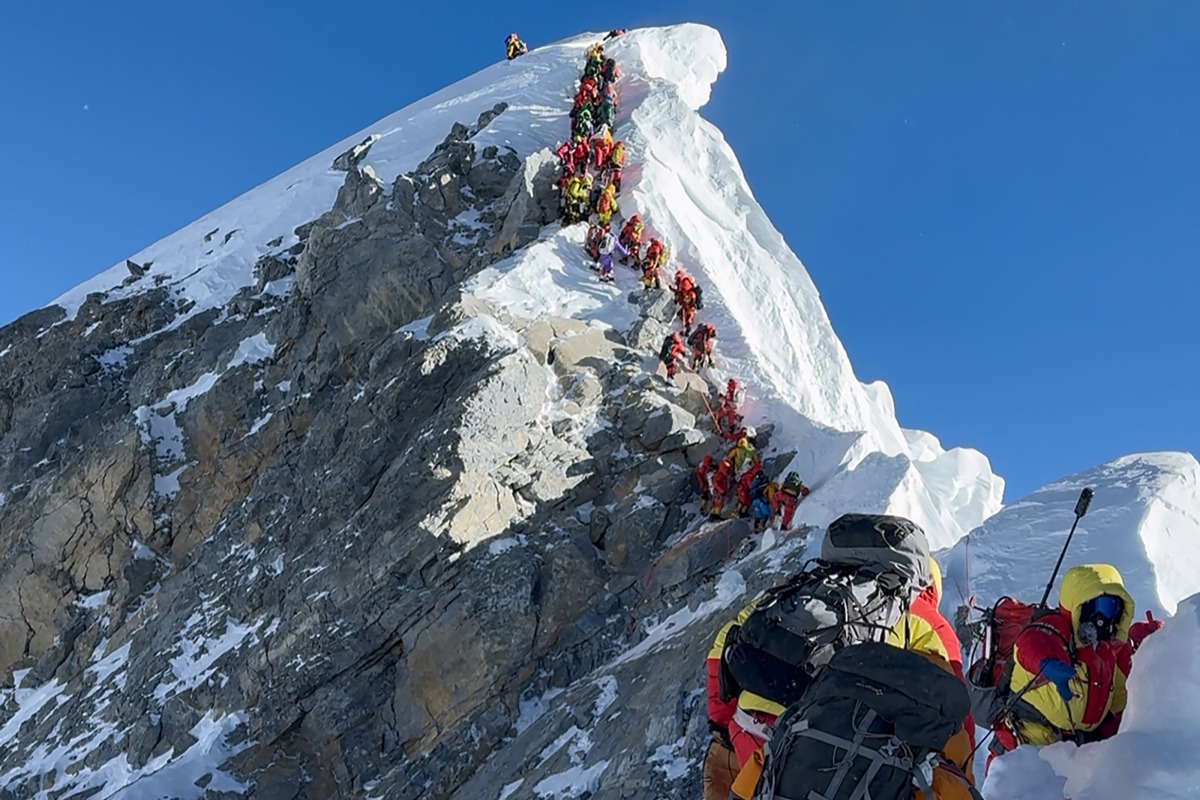 This photograph taken on May 20, 2026, shows mountaineers climbing a slope lined up during their ascent from the Hillary Step to summit Mount Everest in Nepal. Photo by Furte Sherpa / AFP