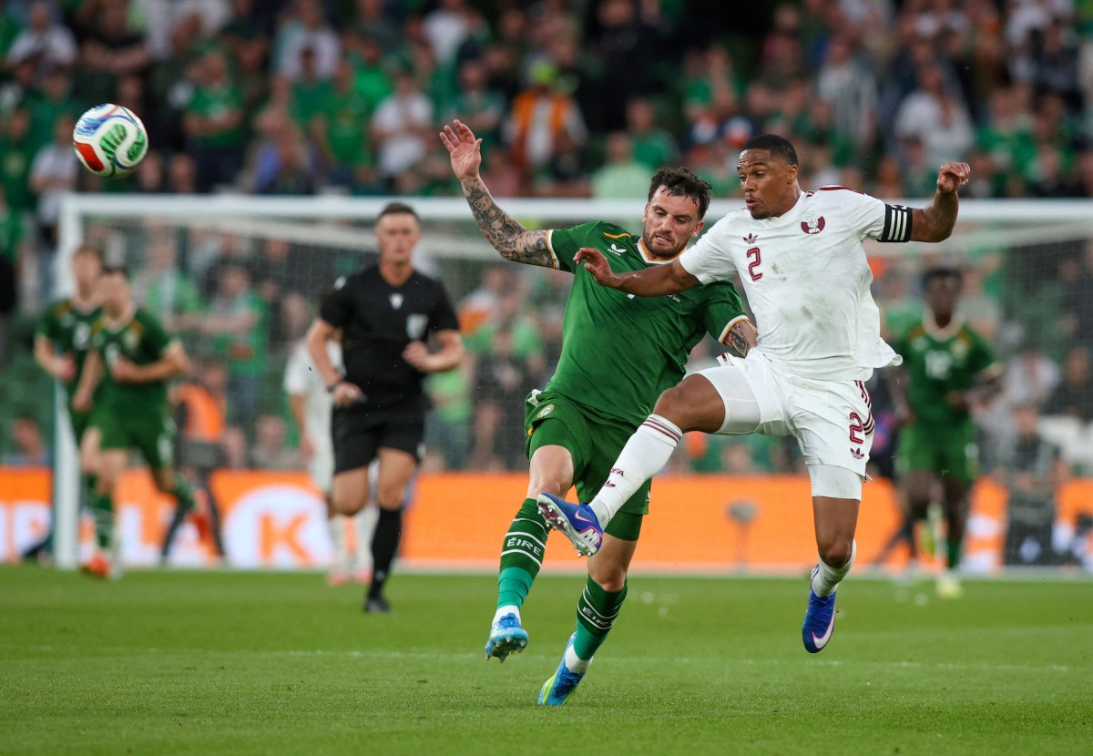 Ireland’s Troy Parrott (left) battles for the ball with Qatar’s Pedro Miguel. (AFP)