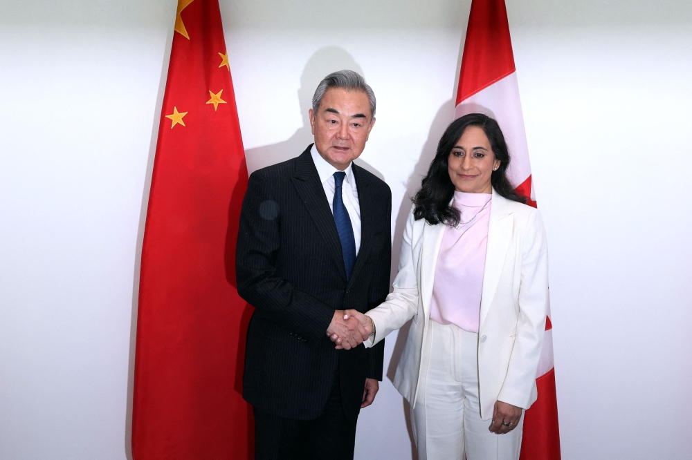 Canada's Minister of Foreign Affairs Anita Anand (R) shakes hands with China's Minister of Foreign Affairs Wang Yi ahead of a bilateral meeting in Ottawa, on May 29, 2026. (Photo by Dave Chan / AFP)
 