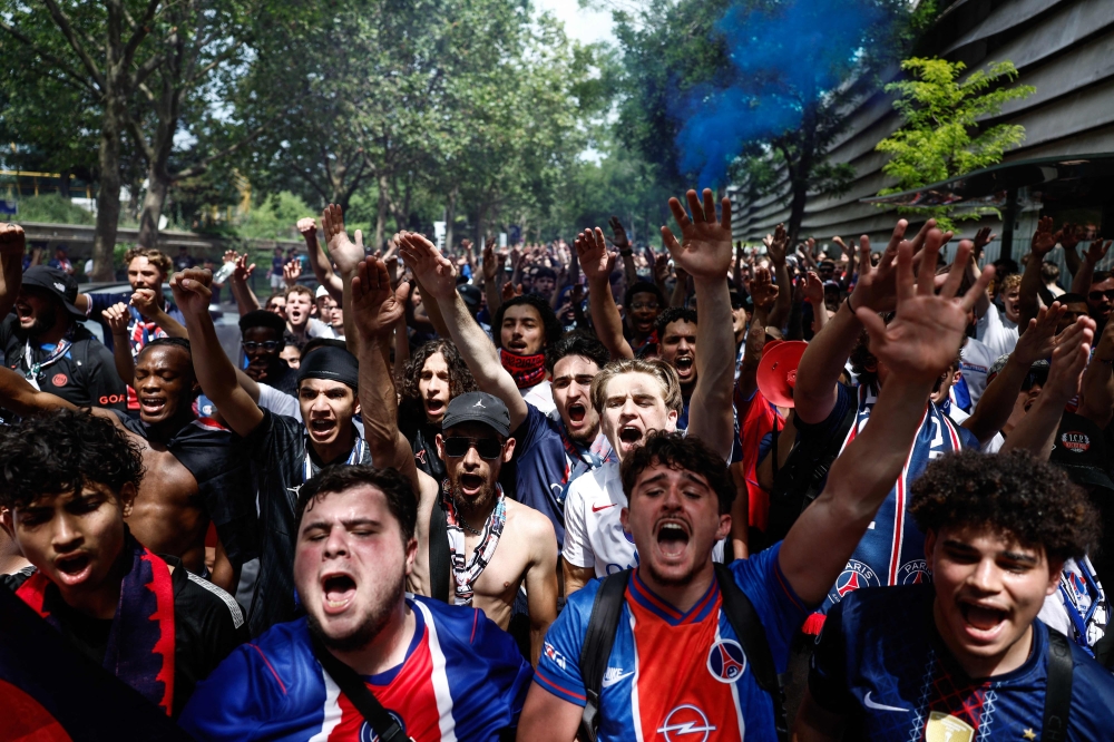PSG supporters chant slogans ahead of the UEFA Champions League Final football match between Paris Saint-Germain (PSG) and Arsenal FC played in Budapest, next to the Parc des Princes stadium, in Paris on May 30, 2026. (Photo by Kenzo Tribouillard / AFP)