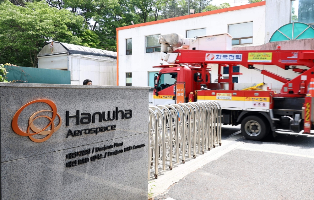 A vehicle of Korea Electric Power Corporation enters the main gate at the Hanwha Aerospace plant in Daejeon on June 1, 2026, after a reported explosion. (Photo by Yonhap / AFP) 