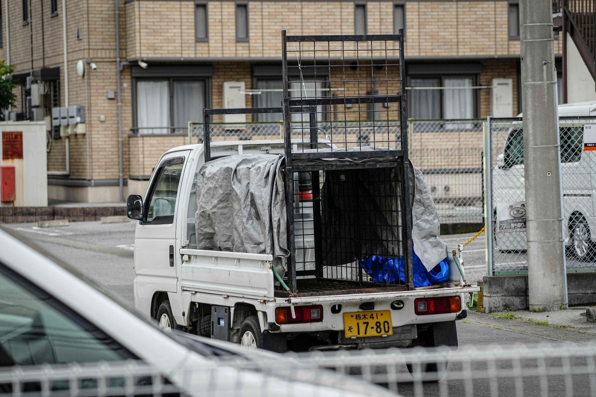 A truck with an animal cage is pictured during the search for a wild bear in Utsunomiya, north of Tokyo, on June 9, 2026. Photo by Yuichi YAMAZAKI / AFP