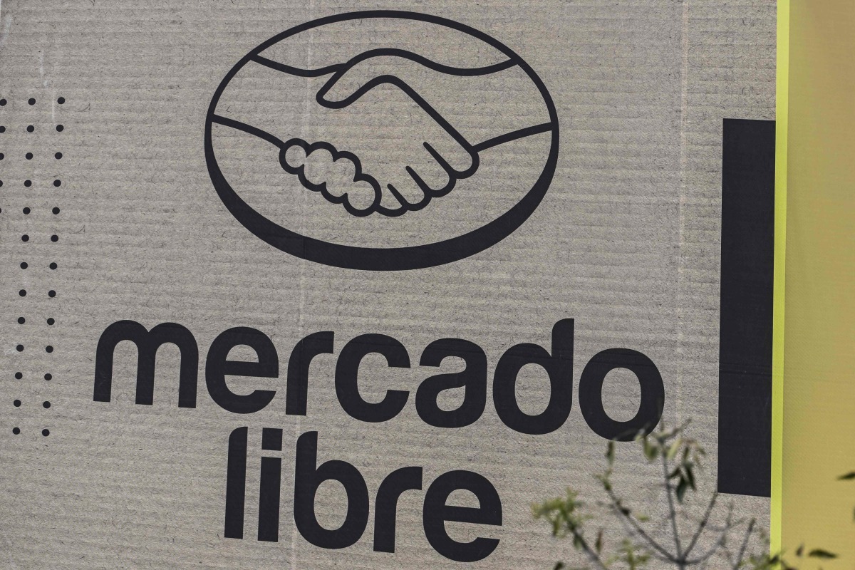 Mercado Libre is displayed on an advertising wall in Mexico City on October 1, 2025. (Photo by Yuri CORTEZ / AFP)