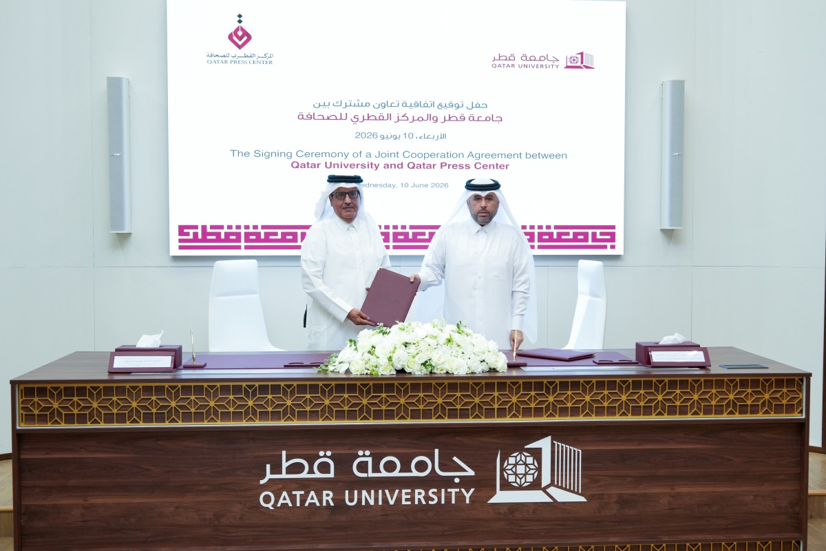 Director General of the Qatar Press Center Sadiq Mohammed Al Amari and Vice President for Academic Affairs at Qatar University Prof Ibrahim Mohammed Al Kaabi exchanging documents after signing the agreement.