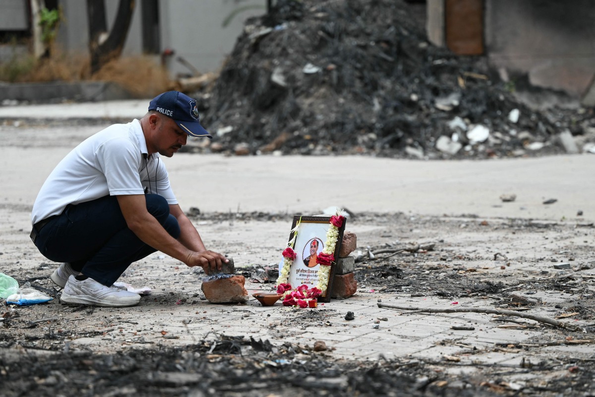 A tribute is set up for Air India Flight 171 plane crash victim Vijay Rupani, former Gujarat chief minister, at the crash site on the first anniversary of the disaster in Ahmedabad on June 12, 2026. Photo by Shammi MEHRA / AFP