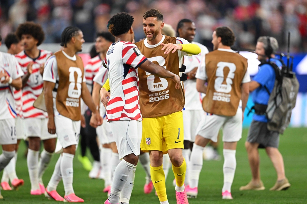US goalkeeper #01 Matt Turner (R) and midfielder #08 Weston McKennie celebrate on June 12, 2026. (Photo by Patrick T. Fallon / AFP)
 