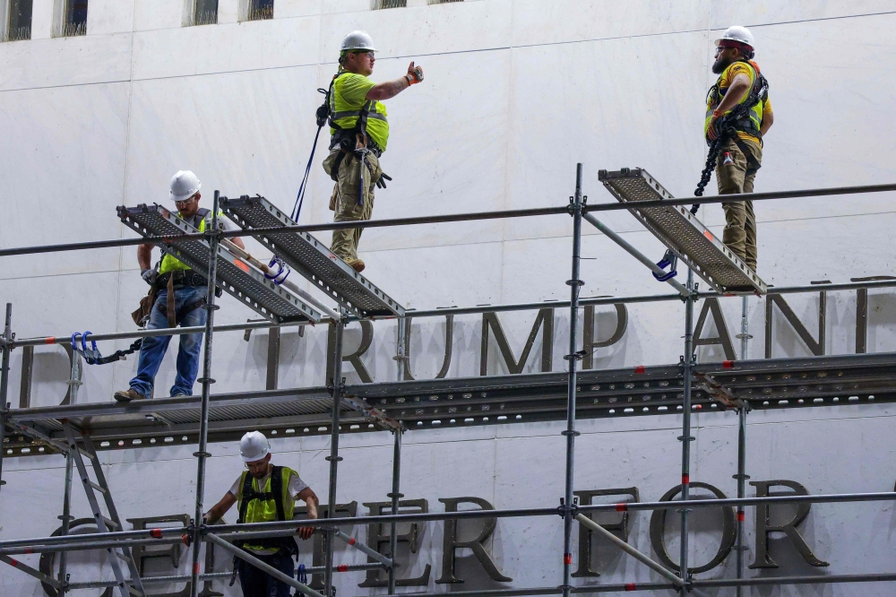 Construction crews build scaffolding outside The Kennedy Center on June 13, 2026 in Washington, DC. Friday marks the court-ordered deadline to remove President Donald trump's name from the Kennedy Center. (Photo by TASOS KATOPODIS / GETTY IMAGES NORTH AMERICA / Getty Images via AFP)