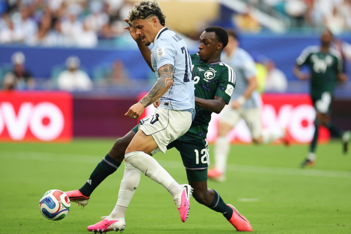 Uruguay's midfielder #20 Maximiliano Araujo and Saudi Arabia's defender #12 Saud Abdulhamid fight for the ball during the 2026 World Cup Group H football match between Saudi Arabia and Uruguay at the Miami Stadium in Miami Gardens on June 15, 2026. (Photo by PATRICIA DE MELO MOREIRA / AFP)
