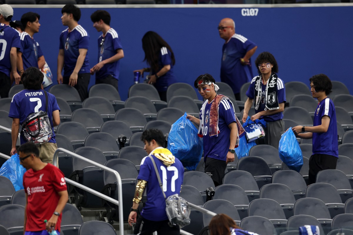 Japan fans clear trash in the stands during the FIFA World Cup 2026 match at Dallas Stadium on June 14, 2026 in Arlington, Texas. Michael Steele/Getty Images/AFP 