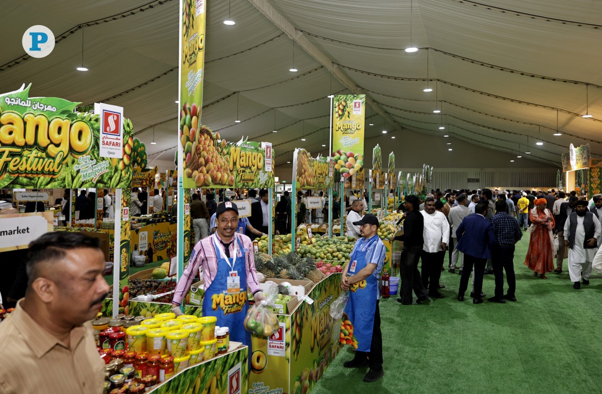 Stalls in Souq Waqif displaying fresh mangoes and other related products from India.