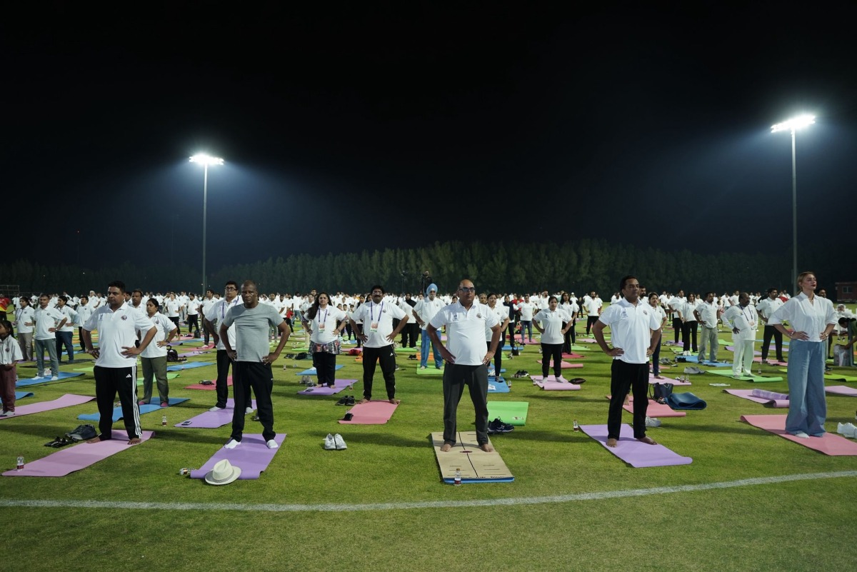 Ambassador of India to Qatar H E Vipul with other participants practising yoga.