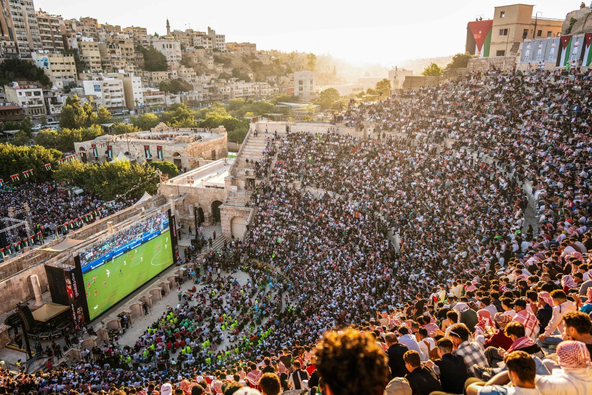 Jordanian football fans gather to watch on giant screens their national team's 2026 World Cup Group J football match against Algeria at Amman's 2nd-century Roman amphitheatre early on June 23, 2026. (Photo by George SAIF / AFP)