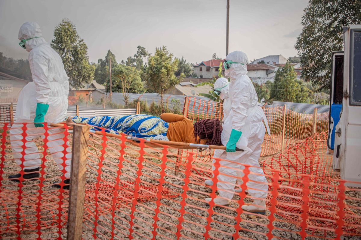 Healthcare workers carry on a stretcher a patient suffering from the Ebola virus disease from an ambulance at the Ebola Treatment Center (ETC) in Bunia, Ituri, in the east of the Democratic Republic of Congo on June 23, 2026. (Photo by Benediction MURHABAZI / AFP)