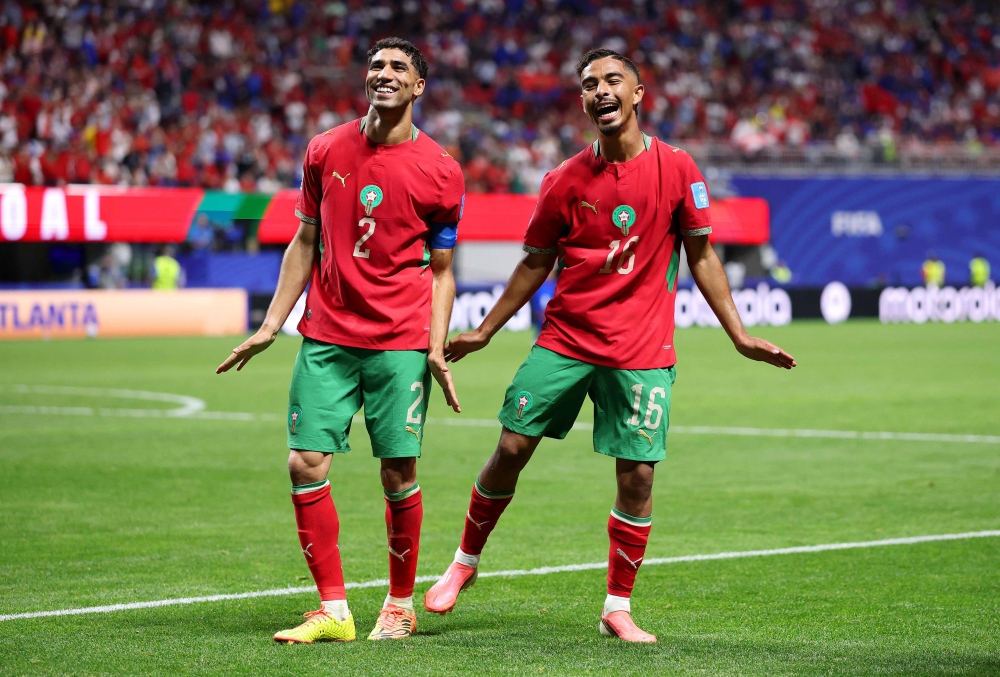 Gessime Yassine #16 of Morocco celebrates with teammate Achraf Hakimi #2 after scoring his team's fourth goal on June 24, 2026 in Atlanta, Georgia. Kevin C. Cox/Getty Images/AFP
